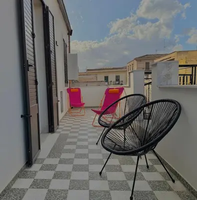three chairs sitting on the balcony of a building at Haus Mignon - Bright flat in Palermo Center in Palermo