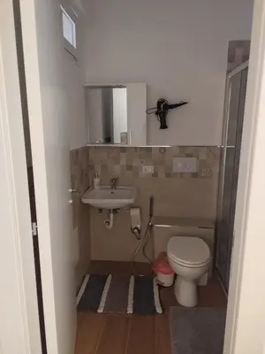 a small bathroom with a toilet and a sink at Appartamento La Perla bianca in Palermo