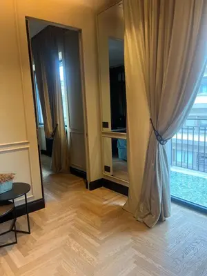 a room with a curtain and a table and a mirror at SCJAVURU of HOME in Palermo