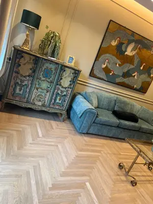 a living room with a blue couch and a table at SCJAVURU of HOME in Palermo