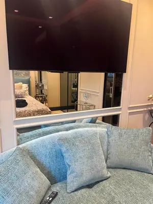a living room with a couch and a large mirror at SCJAVURU of HOME in Palermo