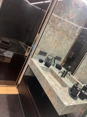a bathroom with a stone sink and a mirror at SCJAVURU of HOME in Palermo