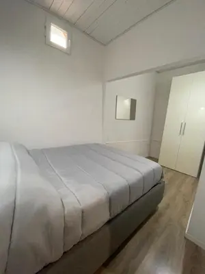 a white bedroom with a bed and white cabinets at Luma Sixty nine in Alcamo