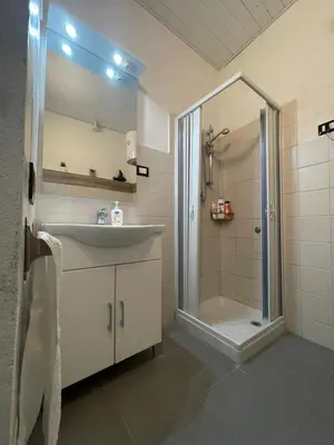 a bathroom with a sink and a shower at Luma Sixty nine in Alcamo