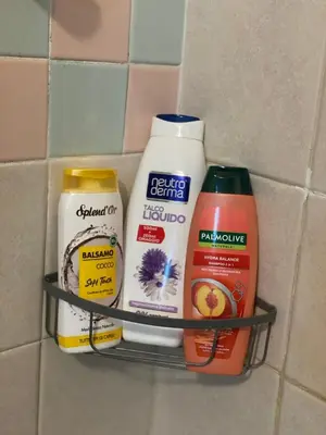 a rack with various cleaning products on a wall at Luma Sixty nine in Alcamo