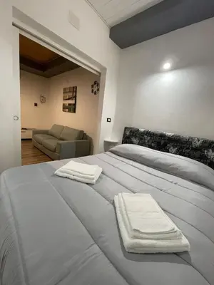 a bedroom with a bed with two towels on it at Luma Sixty nine in Alcamo