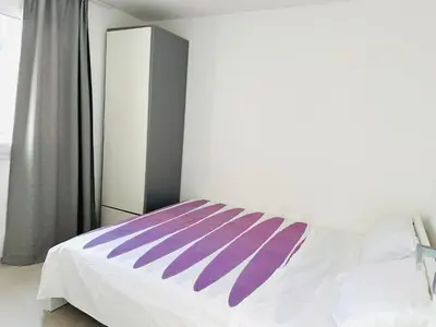 a bedroom with a bed with purple and white sheets at Casa Battigia in Alcamo