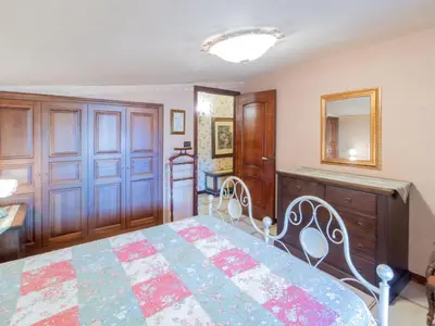 a bedroom with a bed and a dresser and a mirror at Casa San Nicola Trabia Mare in Trabia