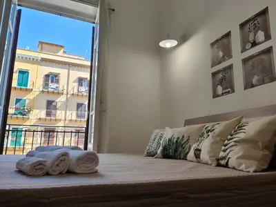 a bedroom with a bed with towels on it at Central Station Apartaments Casa Vacanze in Palermo