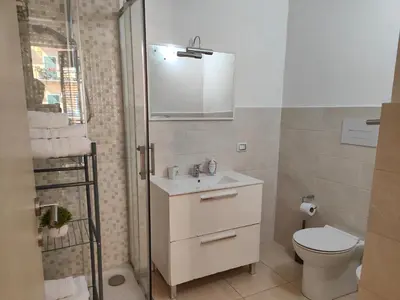 a bathroom with a sink and a toilet and a shower at Central Station Apartaments Casa Vacanze in Palermo