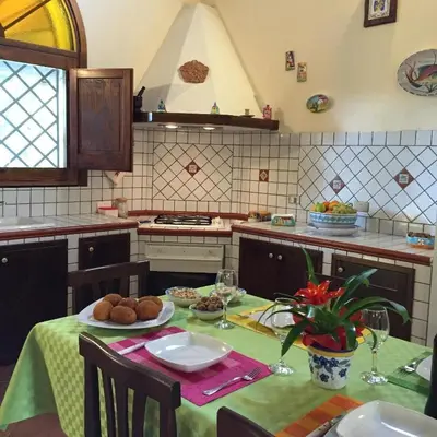 a kitchen with a table with a plate of food on it at Rifugio Giudeo in Balestrate