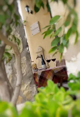 a table with two glasses of wine on it at Rifugio Giudeo in Balestrate