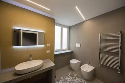 a bedroom with a bed and a brick wall at Romantic Suite in Palermo