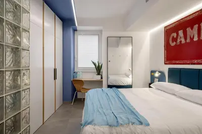 a bedroom with a bed and a desk with a mirror at PAT Amazing & Charm cozy apt in Palermo
