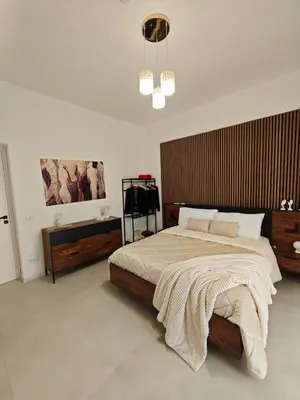 a bedroom with a large bed with a wooden headboard at Alla Metro in Capaci