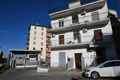 a white car parked in front of a building at Alla Metro in Capaci