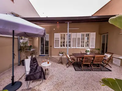 a patio with a table and chairs and an umbrella at Apartment Wohnung dei Mori in Terrasini by Interhome in Terrasini