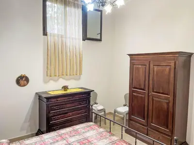a bedroom with a bed and a wooden dresser at Apartment Sea Living Sicilia Apartment by Interhome in Santa Flavia