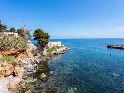 a body of water with a building on a cliff at Apartment Sea Living Sicilia Apartment by Interhome in Santa Flavia