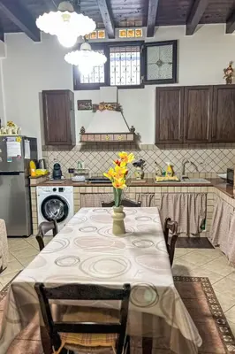 a kitchen with a table with a vase of flowers on it at Apartment Sea Living Sicilia Apartment by Interhome in Santa Flavia