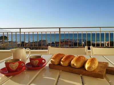 a table with a plate of bread and cups of coffee at Alessandra in Alcamo
