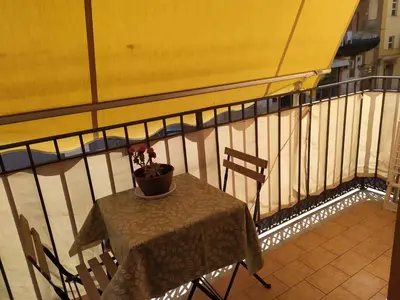 a table and chairs on a balcony at Heidi's home in Villabate