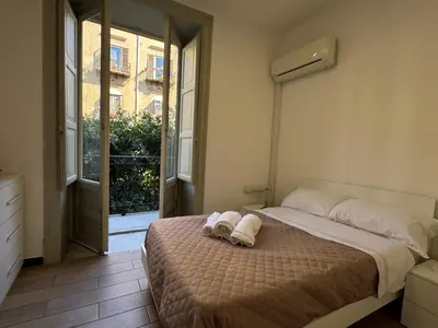 a bedroom with a bed with two towels on it at ÀSicilia Home Holiday in Palermo