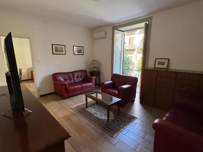 a living room with two couches and a tv at ÀSicilia Home Holiday in Palermo