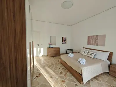 a bedroom with a bed with two towels on it at Kennedy 100 in Capaci