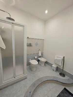 a bathroom with two toilets and a glass shower at Kennedy 100 in Capaci