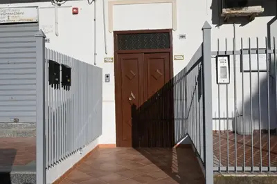 a wooden door on the side of a building at Kennedy 100 in Capaci
