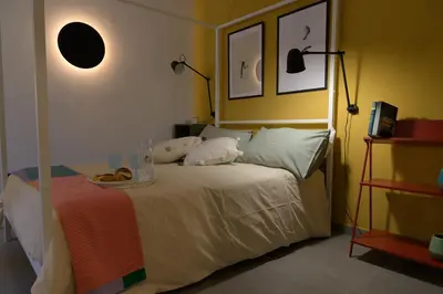 a bedroom with a bed with a tray of donuts on it at Curò in Cinisi