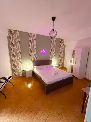 a bedroom with a bed in the middle of a room at Villareale28 suite in Palermo