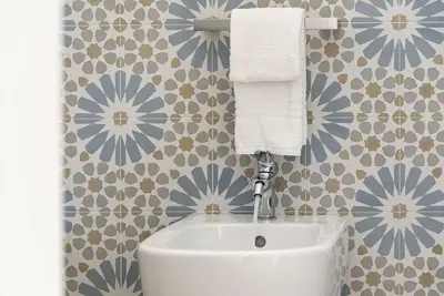 a bathroom with a sink and blue and white tiles at A Casa Di Vale in San Vito lo Capo