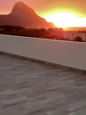 a view of the sunset from the roof of a building at L' arcobaleno in Castelluzzo