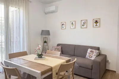a living room with a tv on a wall at S&L Central Apartment in Palermo