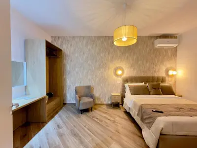 a bedroom with a bed and a desk and a tv at Gemy House in Palermo
