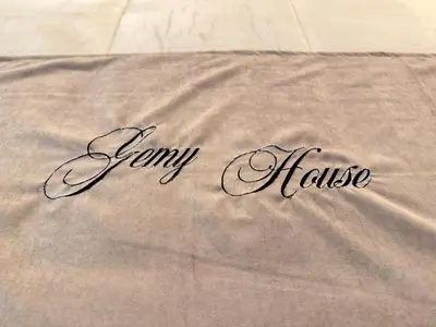 a blanket with the name of aney house on it at Gemy House in Palermo