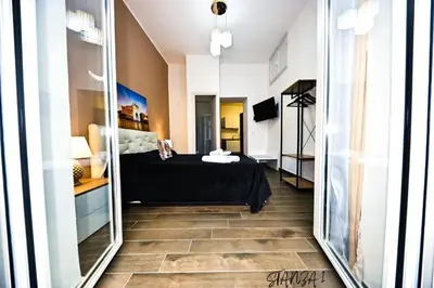 a bedroom with a bed and a mirror at Terra Sicula Ballaroom in Palermo
