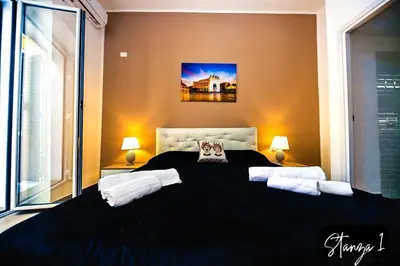 a bedroom with a large black bed with two pillows at Terra Sicula Ballaroom in Palermo