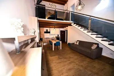 a hallway with a couch and stairs in a building at Terra Sicula Ballaroom 1 in Palermo