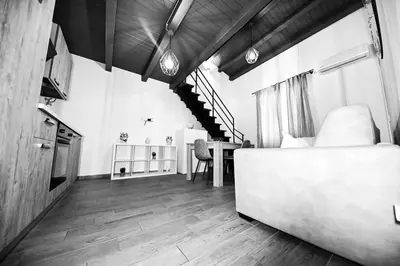 a bedroom with a bed and a table in a room at Terra Sicula Ballaroom 1 in Palermo