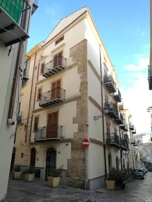 a large white building with balconies on a street at Apartment Papyri in Palermo