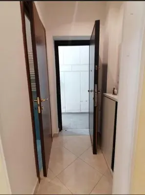 a hallway with a kitchen with a refrigerator at Calandreafamily, appartamento 2 camere da letto vicino al centro Palermo in Palermo