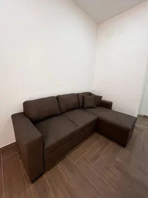 a living room with a television on a table at Zabaria Home - Appartamenti tra Cefalù e Palermo in Casteldaccia