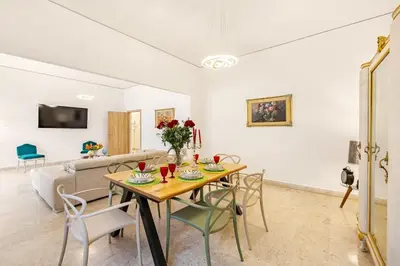 a living room with a table and chairs and a couch at Angelica holiday home in Palermo