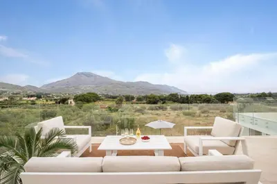 a living room with a couch and chairs and a table at Curina Boutique Stay - Luxury Villa in the Sicilian Countryside in Castellammare del Golfo