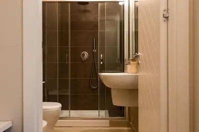 a bathroom with a shower and a sink and a toilet at White and Sea Villa fronte mare a Mondello Addaura in Palermo