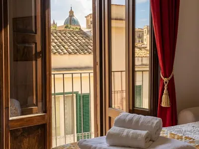 a room with a window with a view of a building at Guglie del centro in Palermo
