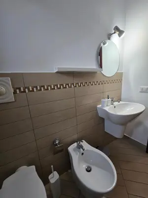 a bathroom with a shower and a toilet and a sink at Guglie del centro in Palermo